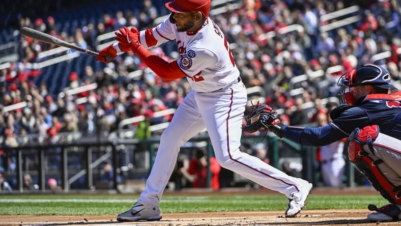 Apr 2, 2023; Washington, District of Columbia, USA; Washington Nationals first baseman Dominic Smith (22) hits an RBI single against the Atlanta Braves during the first inning at Nationals Park. Mandatory Credit: Brad Mills-USA TODAY Sports