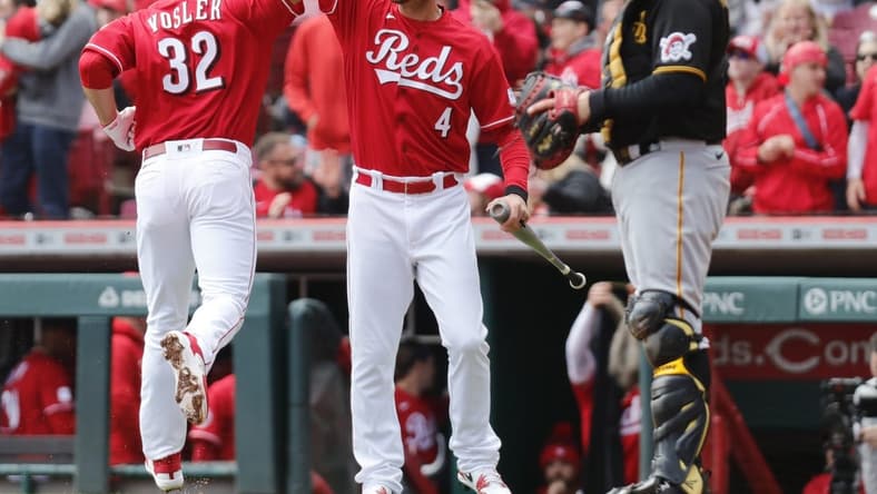 Apr 2, 2023; Cincinnati, Ohio, USA; Cincinnati Reds first  baseman Jason Vosler (32) reacts with designated hitter Wil Myers (4) after hitting a solo home run against the Pittsburgh Pirates during the second inning at Great American Ball Park. Mandatory Credit: David Kohl-USA TODAY Sports