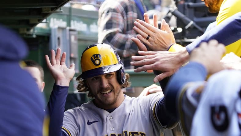 Apr 2, 2023; Chicago, Illinois, USA; Milwaukee Brewers third baseman Brian Anderson (9) is greeted in the dugout after scoring against the Chicago Cubs during the fourth inning at Wrigley Field. Mandatory Credit: David Banks-USA TODAY Sports