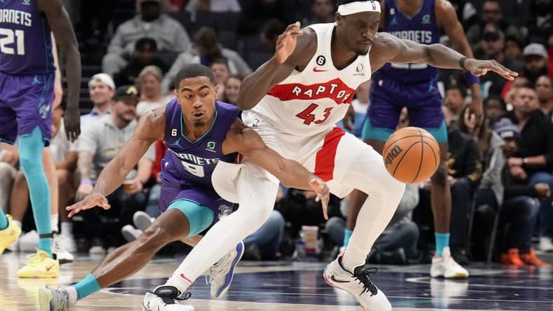 Apr 2, 2023; Charlotte, North Carolina, USA; Charlotte Hornets guard Theo Maledon (9) tries for a steal against Toronto Raptors forward Pascal Siakam (43) during second half at Spectrum Center. Mandatory Credit: Jim Dedmon-USA TODAY Sports