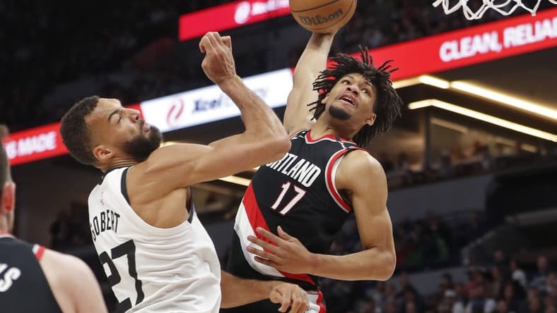 Apr 2, 2023; Minneapolis, Minnesota, USA; Portland Trail Blazers guard Shaedon Sharpe (17) looks to dunk on Minnesota Timberwolves center Rudy Gobert (27) in the first quarter at Target Center. Mandatory Credit: Bruce Kluckhohn-USA TODAY Sports