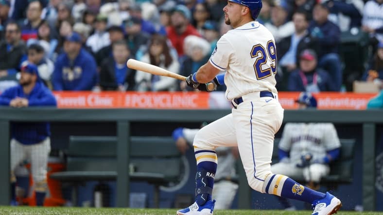 Apr 2, 2023; Seattle, Washington, USA; Seattle Mariners catcher Cal Raleigh (29) hits a two-run double against the Cleveland Guardians during the third inning at T-Mobile Park. Mandatory Credit: Joe Nicholson-USA TODAY Sports