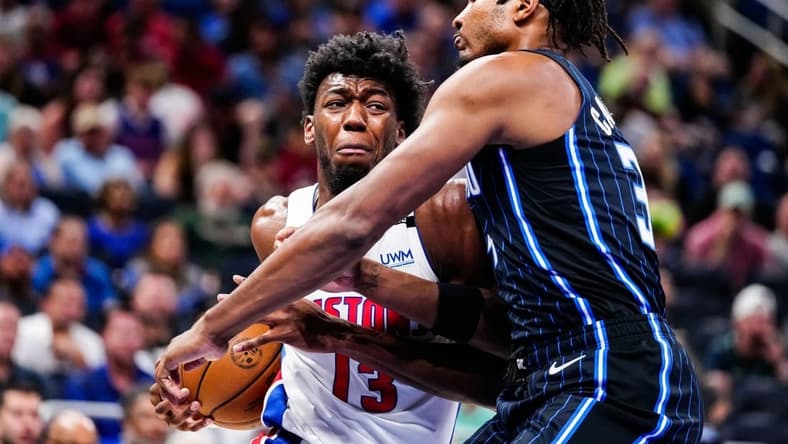 Apr 2, 2023; Orlando, Florida, USA; Detroit Pistons center James Wiseman (13) dribbles the ball past Orlando Magic forward Chuma Okeke (3) during the first quarter at Amway Center. Mandatory Credit: Rich Storry-USA TODAY Sports