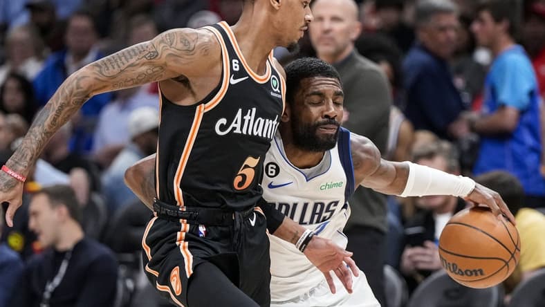 Apr 2, 2023; Atlanta, Georgia, USA; Dallas Mavericks guard Kyrie Irving (2) tries to dribble past Atlanta Hawks guard Dejounte Murray (5) during the first half at State Farm Arena. Mandatory Credit: Dale Zanine-USA TODAY Sports