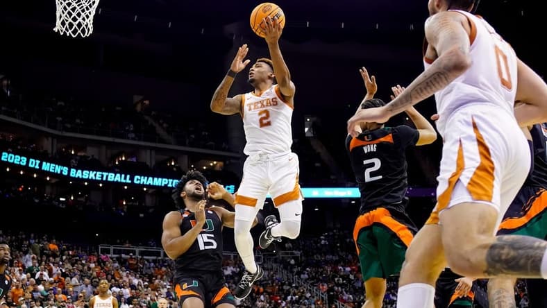 Mar 26, 2023; Kansas City, MO, USA; Texas Longhorns guard Arterio Morris (2) shoots against Miami (Fl) Hurricanes forward Norchad Omier (15) and guard Isaiah Wong (2) during the second half of an Elite 8 college basketball game in the Midwest Regional of the 2023 NCAA Tournament at T-Mobile Center. Mandatory Credit: Jay Biggerstaff-USA TODAY Sports