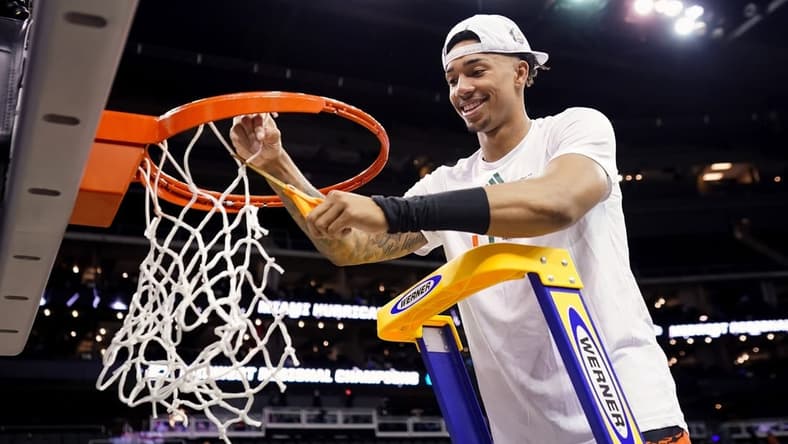 Mar 26, 2023; Kansas City, MO, USA; Miami (Fl) Hurricanes guard Jordan Miller (11) cuts down the net after defeating the Texas Longhorns in an Elite 8 college basketball game in the Midwest Regional of the 2023 NCAA Tournament at T-Mobile Center. Mandatory Credit: Jay Biggerstaff-USA TODAY Sports