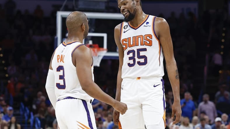 Apr 2, 2023; Oklahoma City, Oklahoma, USA; Phoenix Suns guard Chris Paul (3) and forward Kevin Durant (35) talk during the second half against the Oklahoma City Thunder at Paycom Center. Phoenix won 128-118. Mandatory Credit: Alonzo Adams-USA TODAY Sports