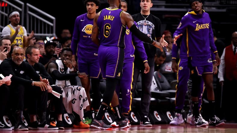 Apr 2, 2023; Houston, Texas, USA; Los Angeles Lakers forward LeBron James (6) shakes hands with teammates on the bench after leaving the game against the Houston Rockets during the fourth quarter at Toyota Center. Mandatory Credit: Erik Williams-USA TODAY Sports