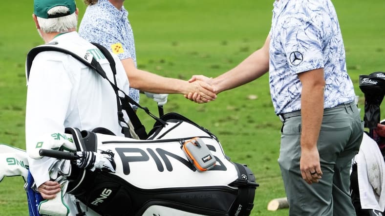 Apr 3, 2023; Augusta, Georgia, USA; Cameron Smith and Jon Rahm shake hands on the practice range during a practice round for The Masters golf tournament at Augusta National Golf Club. Mandatory Credit: Rob Schumacher-USA TODAY Network