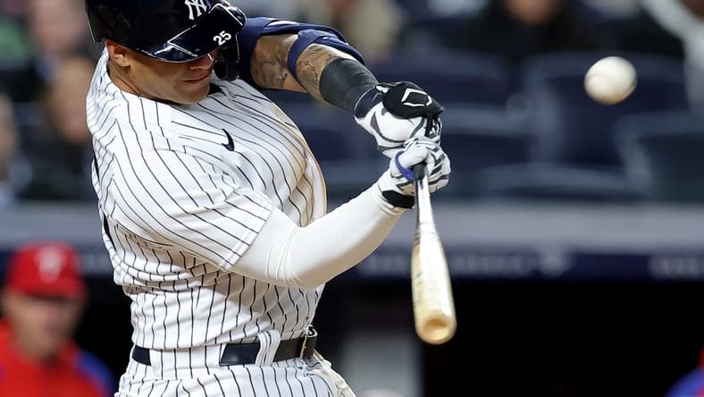 Apr 3, 2023; Bronx, New York, USA; New York Yankees second baseman Gleyber Torres (25) hits a solo home run against the Philadelphia Phillies during the third inning at Yankee Stadium. Mandatory Credit: Brad Penner-USA TODAY Sports