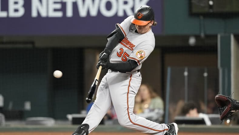 Apr 3, 2023; Arlington, Texas, USA; Baltimore Orioles designated hitter Adley Rutschman (35) hits for a single against the Texas Rangers during the first inning at Globe Life Field. Mandatory Credit: Jim Cowsert-USA TODAY Sports