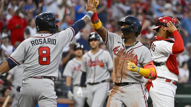 Apr 3, 2023; St. Louis, Missouri, USA;  Atlanta Braves right fielder Ronald Acuna Jr. (13) celebrates with left fielder Eddie Rosario (8) after hitting a three run home run against the St. Louis Cardinals during the second inning at Busch Stadium. Mandatory Credit: Jeff Curry-USA TODAY Sports