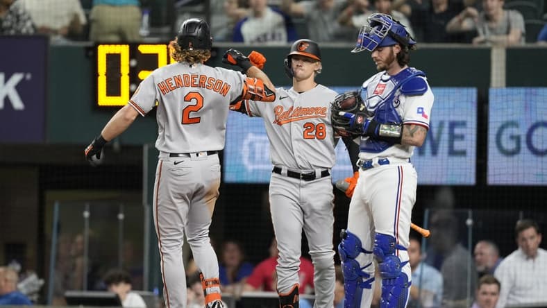 Apr 3, 2023; Arlington, Texas, USA; Baltimore Orioles third base Gunnar Henderson (2) celebrates his solo home run with left fielder Kyle Stowers (28) against the Texas Rangers during the fourth inning at Globe Life Field. Mandatory Credit: Jim Cowsert-USA TODAY Sports