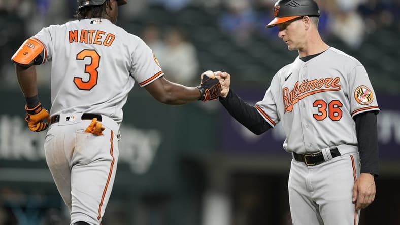 Apr 3, 2023; Arlington, Texas, USA; Baltimore Orioles shortstop Jorge Mateo (3) celebrates his solo home run with third base coach Tony Mansolino (36) against the Texas Rangers during the fifth inning at Globe Life Field. Mandatory Credit: Jim Cowsert-USA TODAY Sports