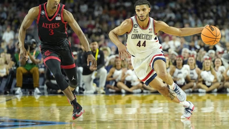 Apr 3, 2023; Houston, TX, USA; Connecticut Huskies guard Andre Jackson Jr. (44) dribbles the ball against San Diego State Aztecs guard Micah Parrish (3) during the first half in the national championship game of the 2023 NCAA Tournament at NRG Stadium. Mandatory Credit: Bob Donnan-USA TODAY Sports