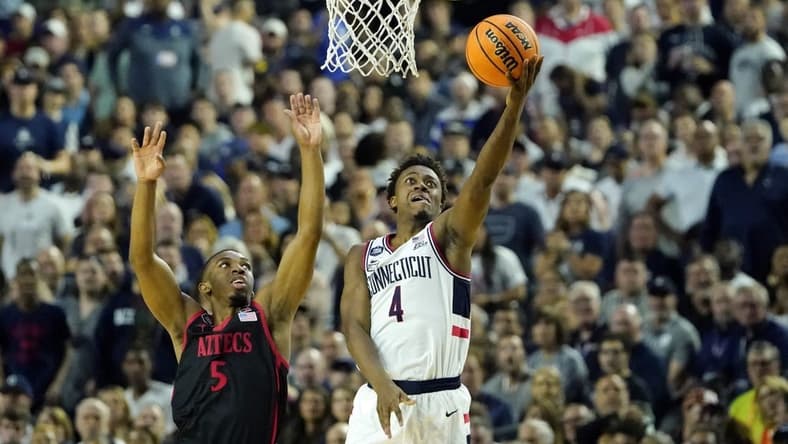 Apr 3, 2023; Houston, TX, USA; Connecticut Huskies guard Nahiem Alleyne (4) shoots the ball against San Diego State Aztecs guard Lamont Butler (5) during the first half in the national championship game of the 2023 NCAA Tournament at NRG Stadium. Mandatory Credit: Bob Donnan-USA TODAY Sports