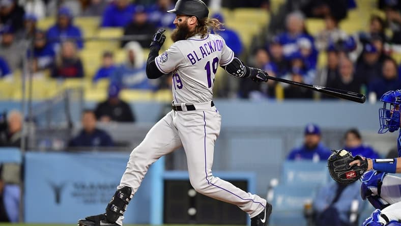 Apr 3, 2023; Los Angeles, California, USA; Colorado Rockies designated hitter Charlie Blackmon (19) reaches first on a fielders choice against the Los Angeles Dodgers during the first inning at Dodger Stadium. Mandatory Credit: Gary A. Vasquez-USA TODAY Sports