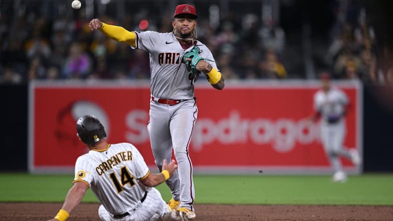 Apr 3, 2023; San Diego, California, USA; Arizona Diamondbacks second baseman Ketel Marte (4) throws to first base after forcing out San Diego Padres designated hitter Matt Carpenter (14) at second base to complete a double play during the third inning at Petco Park. Mandatory Credit: Orlando Ramirez-USA TODAY Sports