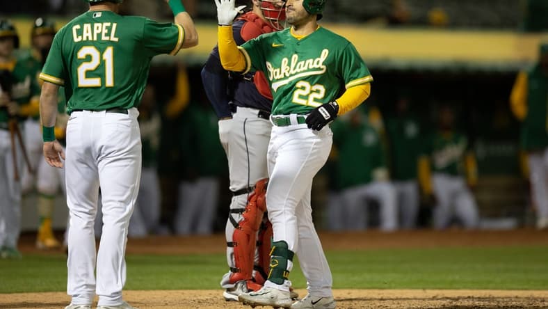 Apr 3, 2023; Oakland, California, USA; Oakland Athletics designated hitter Ram  n Laureano (22) is greeted by teammate Conner Capel (21) after hitting a two-run home run against the Cleveland Guardians during the fifth inning at RingCentral Coliseum. Mandatory Credit: D. Ross Cameron-USA TODAY Sports