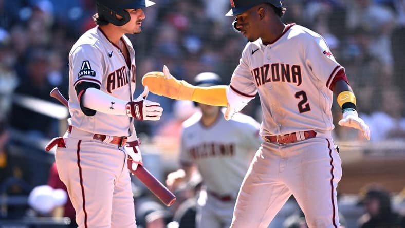 Apr 4, 2023; San Diego, California, USA; Arizona Diamondbacks shortstop Geraldo Perdomo (2) is congratulated by third baseman Josh Rojas (10) after scoring a run during the eighth inning against the San Diego Padres at Petco Park. Mandatory Credit: Orlando Ramirez-USA TODAY Sports