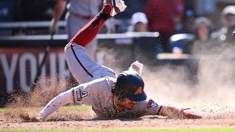 Apr 4, 2023; San Diego, California, USA; Arizona Diamondbacks third baseman Josh Rojas (10) steals home during the eighth inning against the San Diego Padres at Petco Park. Mandatory Credit: Orlando Ramirez-USA TODAY Sports