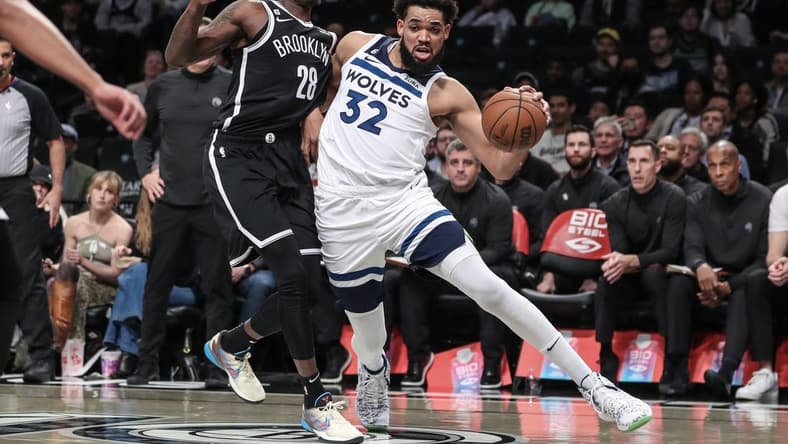 Apr 4, 2023; Brooklyn, New York, USA;  Minnesota Timberwolves center Karl-Anthony Towns (32) looks to drive past Brooklyn Nets forward Dorian Finney-Smith (28) in the first quarter at Barclays Center. Mandatory Credit: Wendell Cruz-USA TODAY Sports