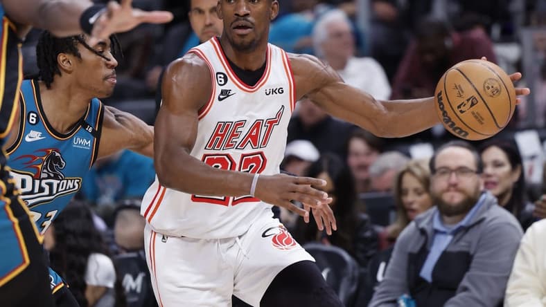Apr 4, 2023; Detroit, Michigan, USA;  Miami Heat forward Jimmy Butler (22) dribbles defended by Detroit Pistons guard Jaden Ivey (23) in the first half at Little Caesars Arena. Mandatory Credit: Rick Osentoski-USA TODAY Sports