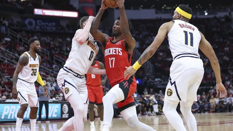 Apr 4, 2023; Houston, Texas, USA; Houston Rockets forward Tari Eason (17) drives with the ball as Denver Nuggets guard Christian Braun (0) defends during the second quarter at Toyota Center. Mandatory Credit: Troy Taormina-USA TODAY Sports
