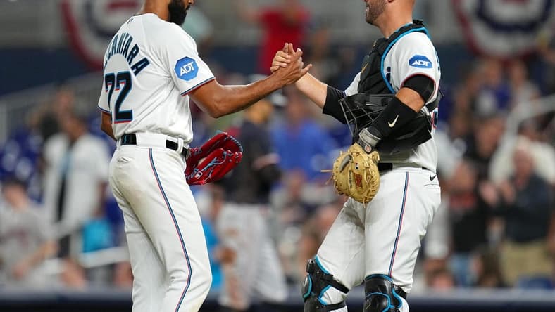 Apr 4, 2023; Miami, Florida, USA;  Miami Marlins starting pitcher Sandy Alcantara (22) shakes hands with catcher Jacob Stallings (58) after a complete game over the Minnesota Twins at loanDepot Park. Mandatory Credit: Jim Rassol-USA TODAY Sports
