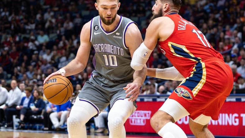 Apr 4, 2023; New Orleans, Louisiana, USA;  Sacramento Kings forward Domantas Sabonis (10) dribbles against New Orleans Pelicans center Jonas Valanciunas (17) during the first half at Smoothie King Center. Mandatory Credit: Stephen Lew-USA TODAY Sports