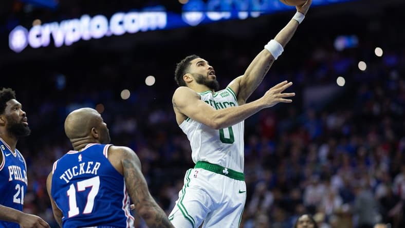 Apr 4, 2023; Philadelphia, Pennsylvania, USA; Boston Celtics forward Jayson Tatum (0) drives for a score past Philadelphia 76ers forward P.J. Tucker (17) and center Joel Embiid (21) during the second quarter at Wells Fargo Center. Mandatory Credit: Bill Streicher-USA TODAY Sports