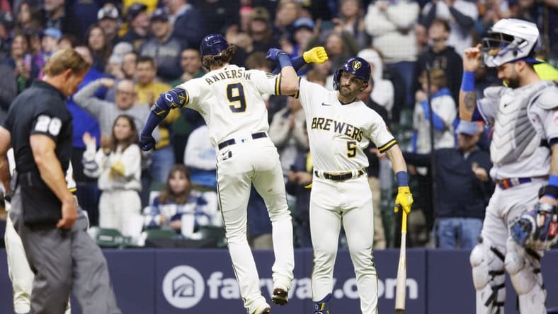 Apr 4, 2023; Milwaukee, Wisconsin, USA;  Milwaukee Brewers third baseman Brian Anderson (9) celebrates with center fielder Garrett Mitchell (5) after hitting a home run during the sixth inning against the New York Mets at American Family Field. Mandatory Credit: Jeff Hanisch-USA TODAY Sports