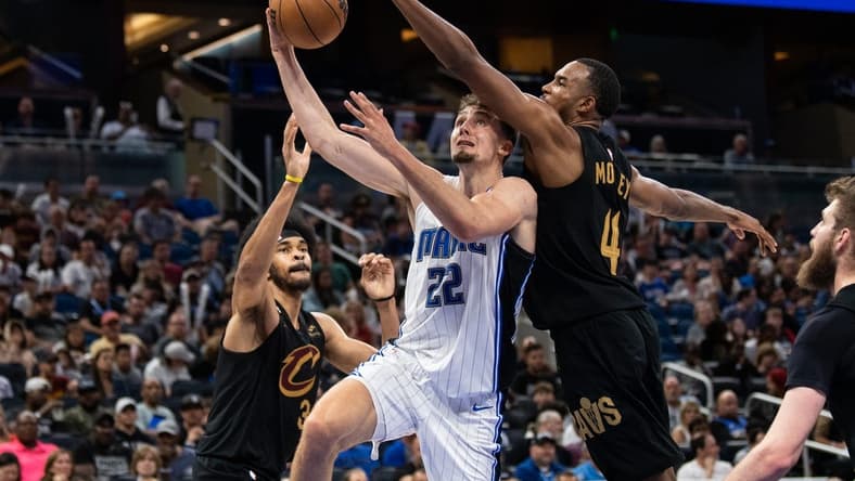 Apr 4, 2023; Orlando, Florida, USA; Orlando Magic forward Franz Wagner (22) shoots the ball against Cleveland Cavaliers forward Evan Mobley (4) in the fourth quarter at Amway Center. Mandatory Credit: Jeremy Reper-USA TODAY Sports