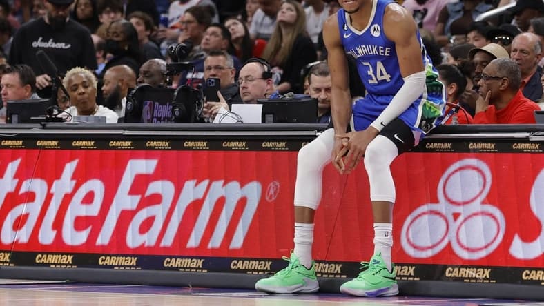 Apr 4, 2023; Washington, District of Columbia, USA; Milwaukee Bucks forward Giannis Antetokounmpo (34) sits on the scorers table against the Washington Wizards in the fourth quarter at Capital One Arena. Mandatory Credit: Geoff Burke-USA TODAY Sports
