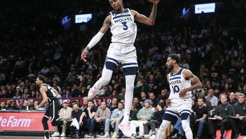 Apr 4, 2023; Brooklyn, New York, USA;  Minnesota Timberwolves forward Jaden McDaniels (3) grabs a rebound in the fourth quarter against the Brooklyn Nets at Barclays Center. Mandatory Credit: Wendell Cruz-USA TODAY Sports