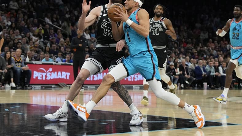 Apr 4, 2023; Phoenix, Arizona, USA; Phoenix Suns guard Devin Booker (1) drives on San Antonio Spurs forward Sandro Mamukelashvili (54) in the first half at Footprint Center. Mandatory Credit: Rick Scuteri-USA TODAY Sports