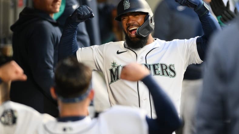 Apr 4, 2023; Seattle, Washington, USA; Seattle Mariners right fielder Teoscar Hernandez celebrates in the dugout after hitting a home run against the Los Angeles Angels during the fourth inning at T-Mobile Park. Mandatory Credit: Steven Bisig-USA TODAY Sports