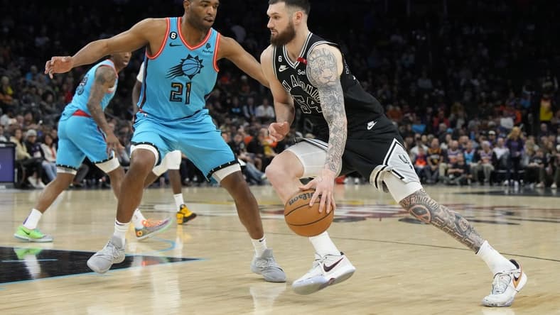 Apr 4, 2023; Phoenix, Arizona, USA; San Antonio Spurs forward Sandro Mamukelashvili (54) drives on Phoenix Suns forward T.J. Warren (21) in the second half at Footprint Center. Mandatory Credit: Rick Scuteri-USA TODAY Sports