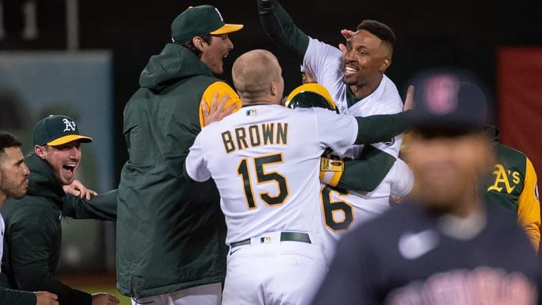 Apr 4, 2023; Oakland, California, USA; Oakland Athletics second baseman Tony Kemp (5) celebrates with team mates after hitting a game winning single during the ninth inning of the game against the Cleveland Guardians at RingCentral Coliseum. Mandatory Credit: Ed Szczepanski-USA TODAY Sports