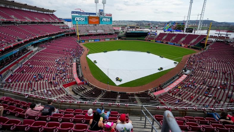 The tarp covers the field as a rain delay is announced before the first inning of the MLB National League game between the Cincinnati Reds and the Chicago Cubs at Great American Ball Park in downtown Cincinnati on Wednesday, April 5, 2023.

Chicago Cubs At Cincinnati Reds