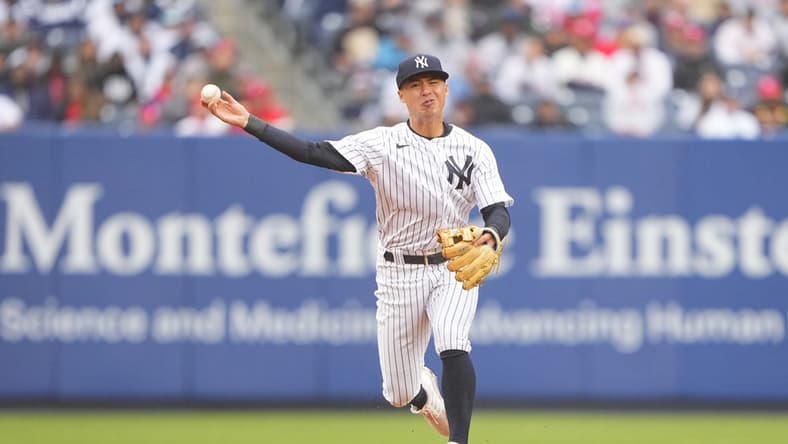 Apr 5, 2023; Bronx, New York, USA; New York Yankees shortstop Anthony Volpe (11) throws out Philadelphia Phillies catcher J.T. Realmuto (10) after fielding a ground ball during the fourth inning at Yankee Stadium. Mandatory Credit: Gregory Fisher-USA TODAY Sports