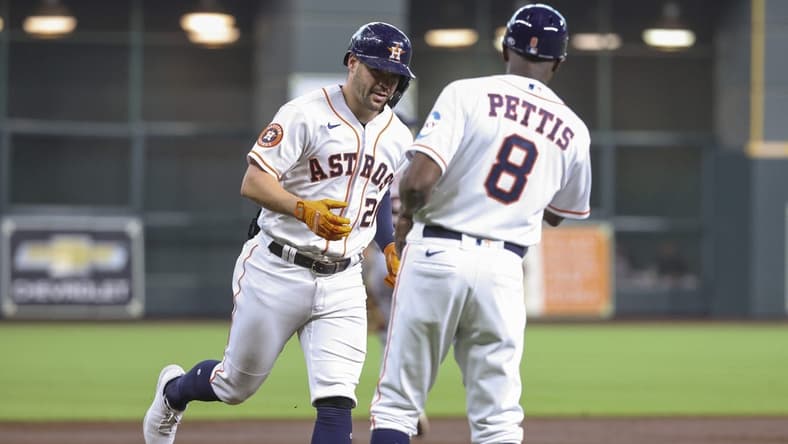 Apr 5, 2023; Houston, Texas, USA; Houston Astros center fielder Chas McCormick (20) celebrates with third base coach Gary Pettis (8) after hitting a home run during the second inning against the Detroit Tigers at Minute Maid Park. Mandatory Credit: Troy Taormina-USA TODAY Sports
