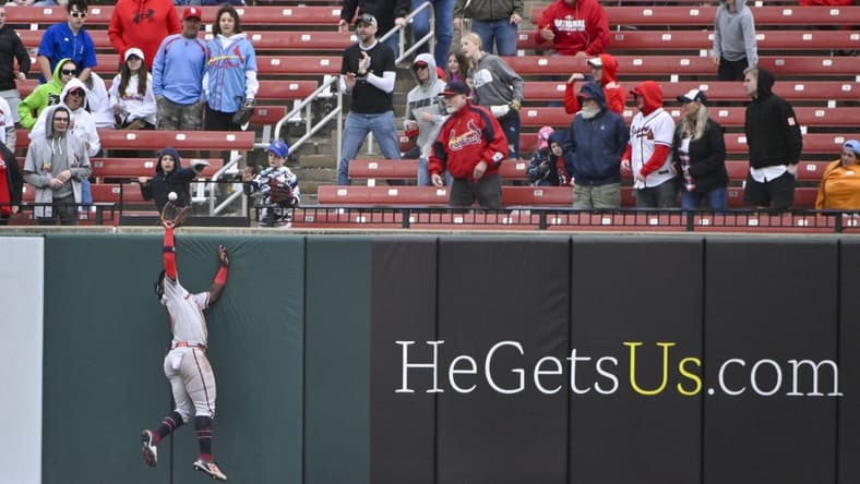 Apr 5, 2023; St. Louis, Missouri, USA;  Atlanta Braves center fielder Michael Harris II (23) leaps at the wall and robs St. Louis Cardinals first baseman Paul Goldschmidt (not pictured) of a two run home run to end the eighth inning at Busch Stadium. Mandatory Credit: Jeff Curry-USA TODAY Sports