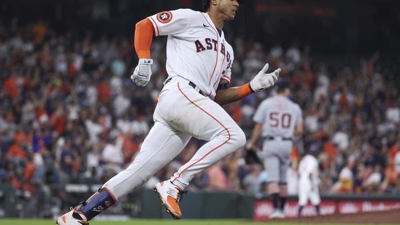 Apr 5, 2023; Houston, Texas, USA; Detroit Tigers relief pitcher Garrett Hill (50) reacts and Houston Astros shortstop Jeremy Pena (3) runs to first base on a double during the seventh inning at Minute Maid Park. Mandatory Credit: Troy Taormina-USA TODAY Sports