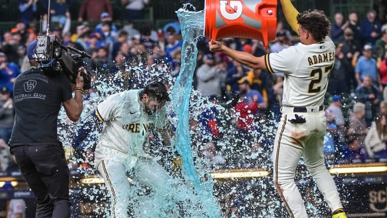 Apr 5, 2023; Milwaukee, Wisconsin, USA; Milwaukee Brewers shortstop Willy Adames (27) dunks left fielder Garrett Mitchell (5) after hitting the game-winning home run in the ninth inning against the New York Mets at American Family Field. Mandatory Credit: Benny Sieu-USA TODAY Sports