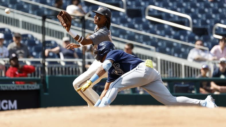 Apr 5, 2023; Washington, District of Columbia, USA; Tampa Bay Rays center fielder Jose Siri (22) is tagged out at third base on a throw to Washington Nationals shortstop CJ Abrams (5) during the sixth inning at Nationals Park. Mandatory Credit: Geoff Burke-USA TODAY Sports