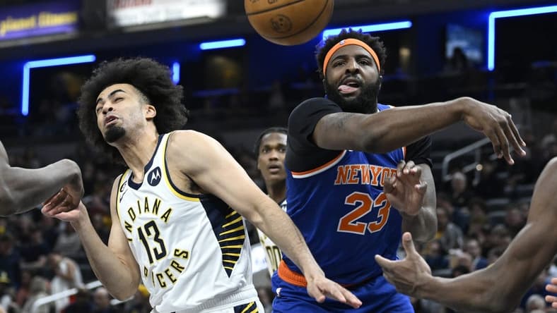 Apr 5, 2023; Indianapolis, Indiana, USA;  New York Knicks center Mitchell Robinson (23) knocks a rebound away from Indiana Pacers forward Jordan Nwora (13) during the first half at Gainbridge Fieldhouse. Mandatory Credit: Marc Lebryk-USA TODAY Sports