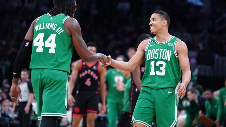Apr 5, 2023; Boston, Massachusetts, USA; Boston Celtics guard Malcolm Brogdon (13) reacts after his three point basket with center Robert Williams III (44) against the Toronto Raptors in the second quarter at TD Garden. Mandatory Credit: David Butler II-USA TODAY Sports