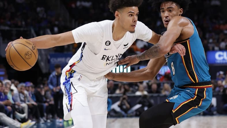 Apr 5, 2023; Detroit, Michigan, USA;  Brooklyn Nets forward Cameron Johnson (2) dribbles on Detroit Pistons guard Jared Rhoden (8) in the first half at Little Caesars Arena. Mandatory Credit: Rick Osentoski-USA TODAY Sports