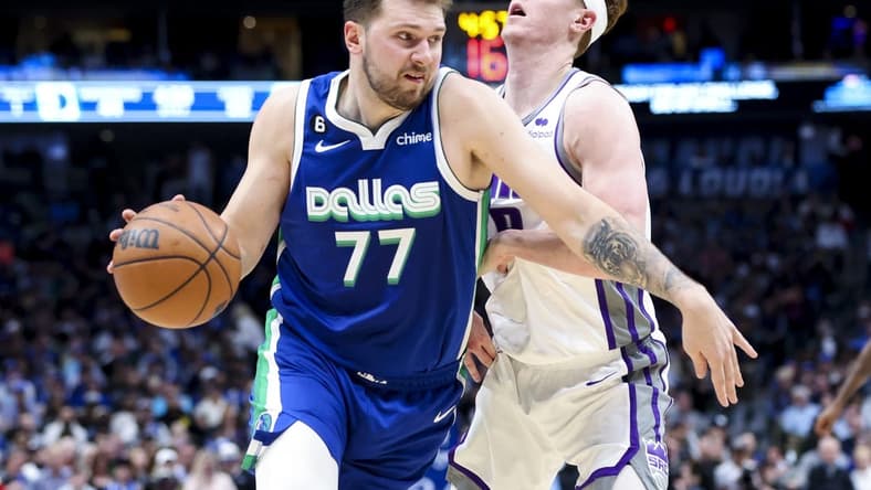 Apr 5, 2023; Dallas, Texas, USA;  Dallas Mavericks guard Luka Doncic (77) drives to the basket as Sacramento Kings guard Kevin Huerter (9) defends during the second quarter at American Airlines Center. Mandatory Credit: Kevin Jairaj-USA TODAY Sports